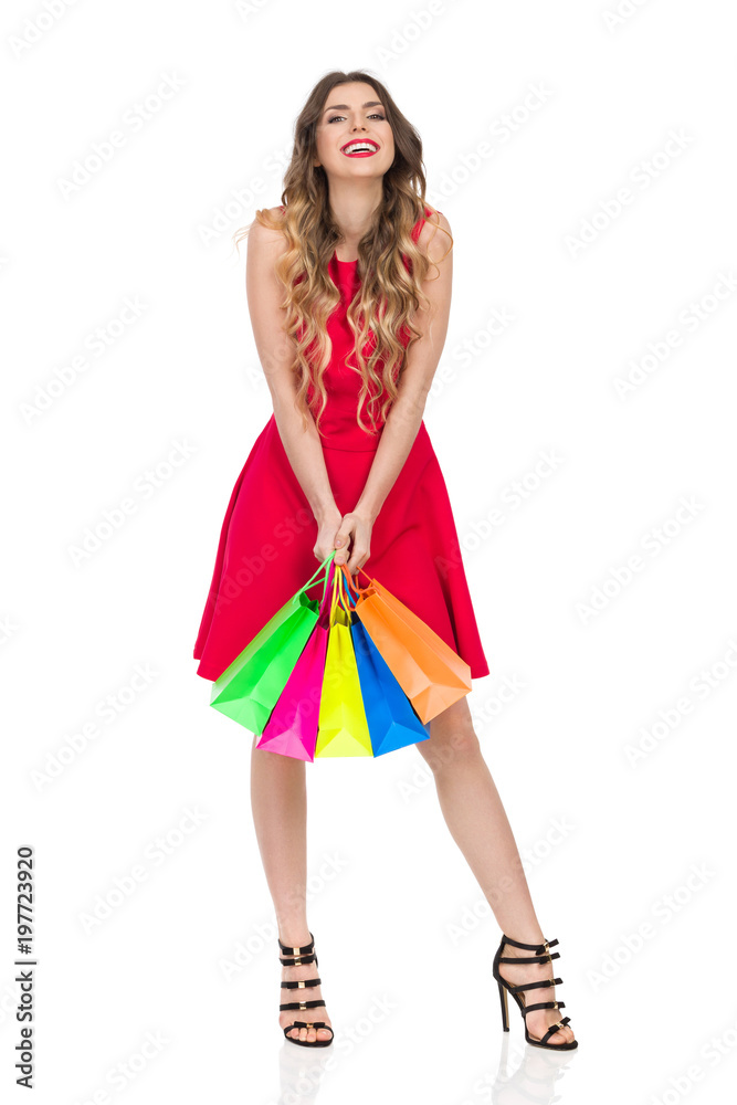 Laughing Woman In Red Dress Is Holding Colorful Shopping Bags Laughing Woman In Red Dress Is Holding Colorful Shopping Bags