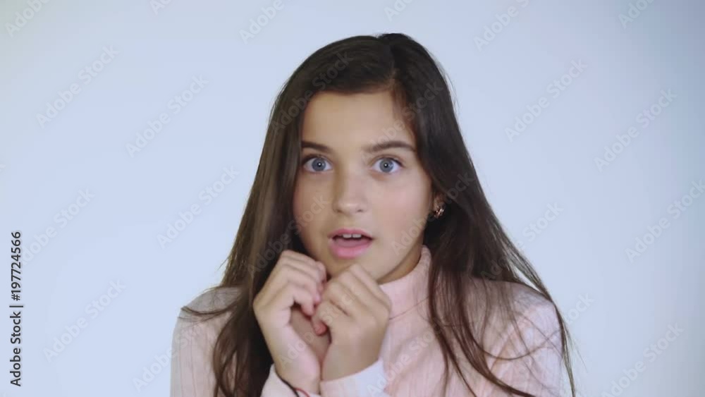 Portrait of afraid and shocked young girl looking on background Portrait of afraid and shocked young girl looking on background