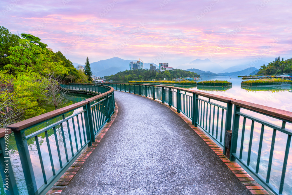 Fototapeta premium Landscape view of Sun Moon Lake with colorful sunrise sky dawn morning, the most famous tourist attraction in Taiwan.