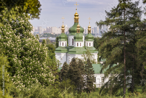 Botanical garden with blooming lilac, spring landscape, St. George Cathedral of the Vydubychi Monastery, view on Dnipro river, Kyiv, Ukraine