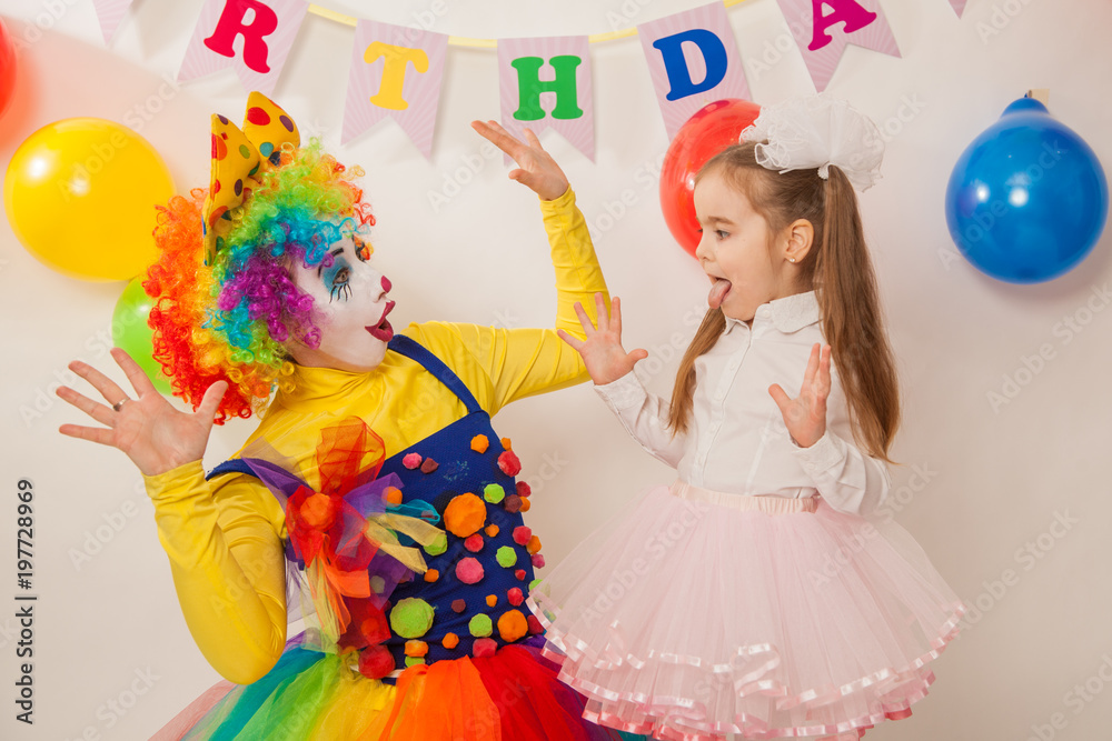 clown girl on the birthday of a child. A party for a child. shy Baby clown girl on the birthday of a child. A party for a child. shy Baby