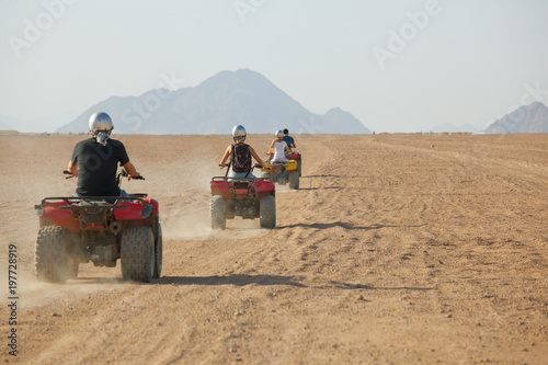 Εκτύπωση καμβά high speed race of several people riding quad bikes in desert of Egypt