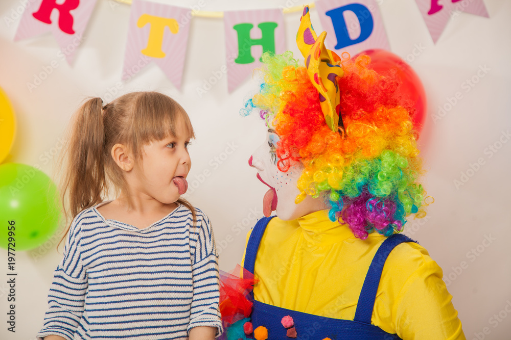 clown girl on the birthday of a child. A party for a child. Emotional Child fools around clown girl on the birthday of a child. A party for a child. Emotional Child fools around