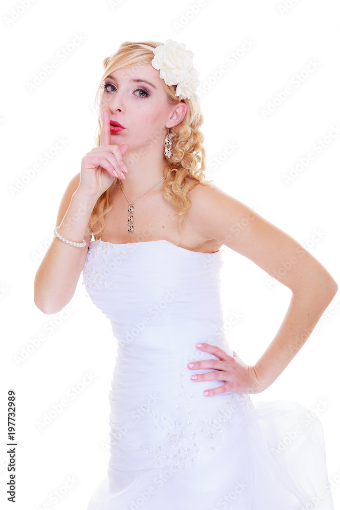 Bride in white wedding dress showing silence sign Bride in white wedding dress showing silence sign