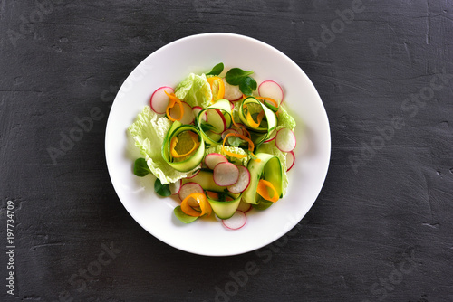 Vegetable salad on dark stone background