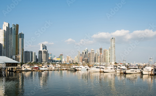 Vacations and Tourism Concept - modern yachts at harbor in Panama with city skyline