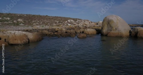 4K high quality aerial video footage of Western Cape's coast, Paternoster beach boulders, sandy sea front and Atlantic Ocean views in the background near Cape Town, South Africa on summer morning photo