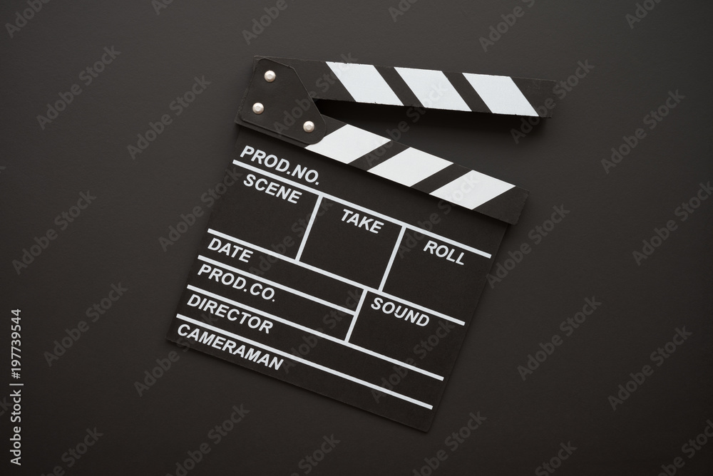 Naklejka premium Cinema clapperboard on blackboard background - Movie entertainment concept