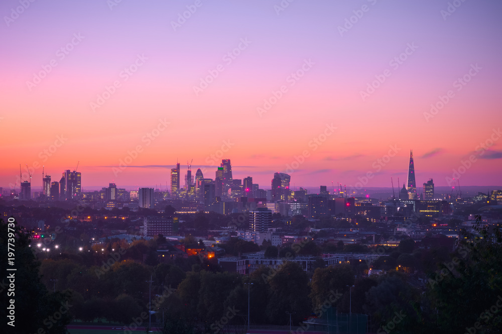 Naklejka premium View towards London city skyline at sunrise from parliament hill in Hampstead Heath