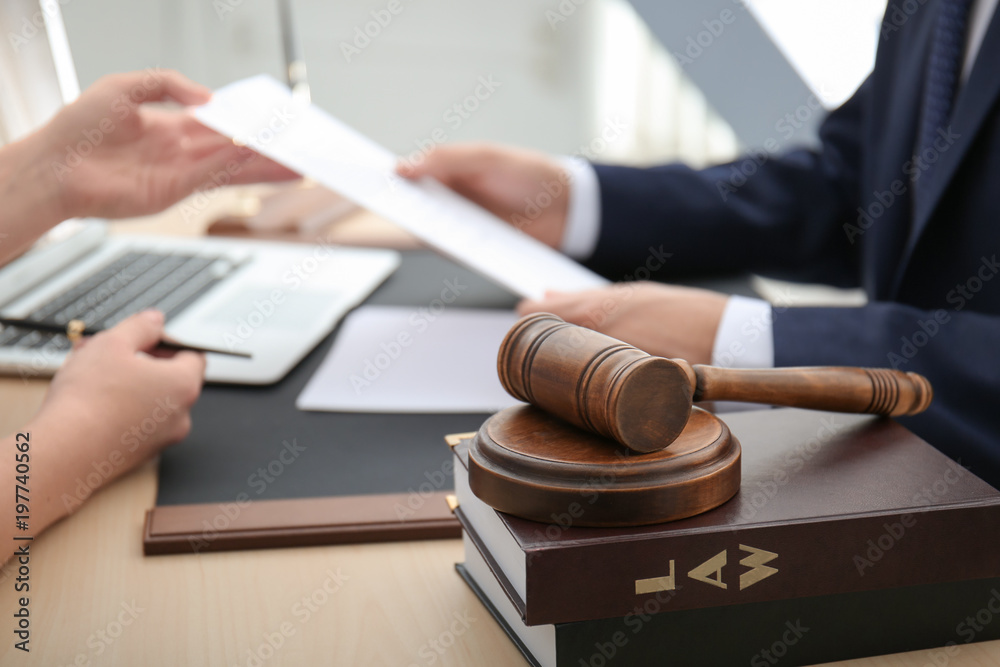 Gavel with juridical books on table in lawyer's office Gavel with juridical books on table in lawyer's office