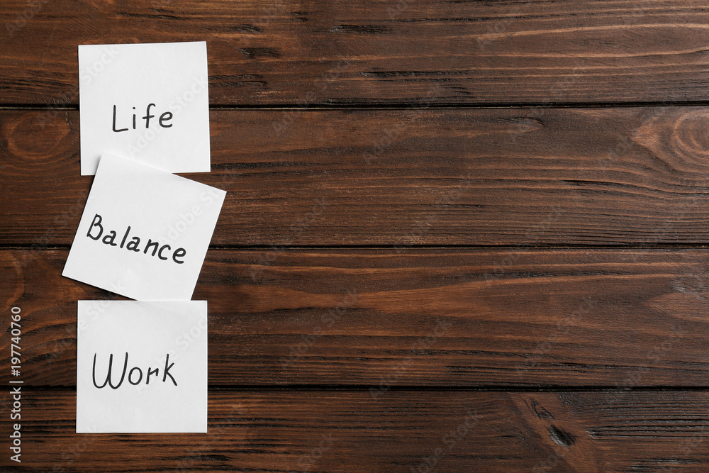 Notes with words WORK, LIFE and BALANCE on wooden background Notes with words WORK, LIFE and BALANCE on wooden background