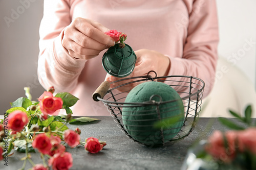 Female florist using sponge for work at table