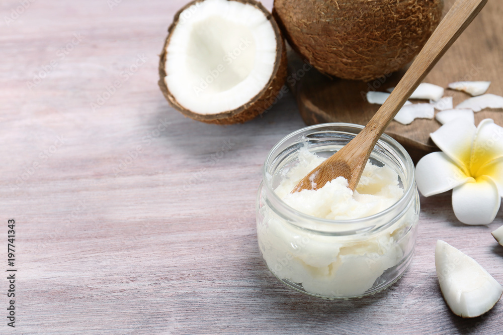 Beautiful composition with coconut oil and nuts on wooden background Beautiful composition with coconut oil and nuts on wooden background