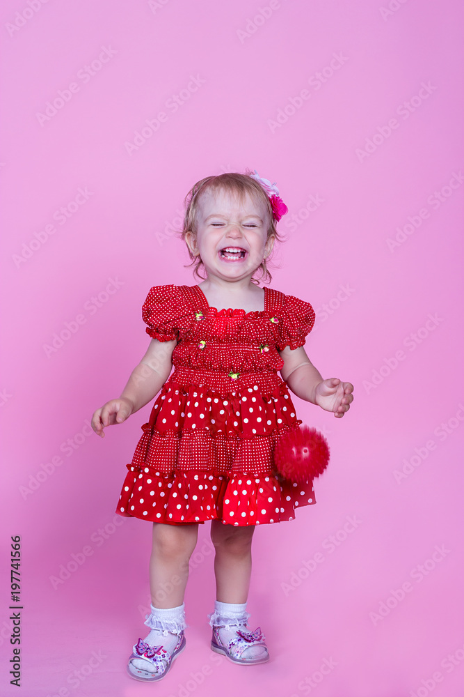 little girl laughing on a pink background little girl laughing on a pink background