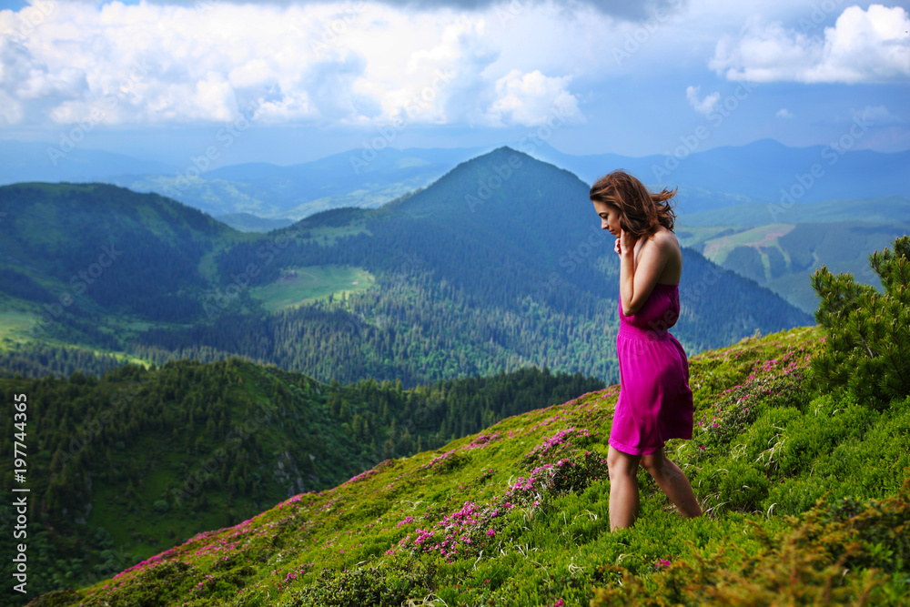 The girl enjoys landscapes in the mountains of the Carpathians.