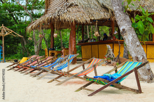 Colorful chairs on the island near an exotic bar