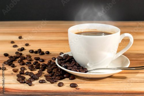 Coffee cup and coffee beans on table