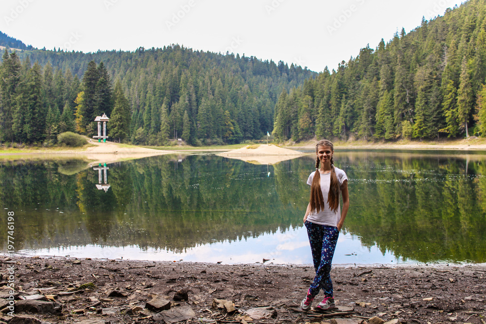 Young woman walk near mountain lake, harmony concept Young woman walk near mountain lake, harmony concept