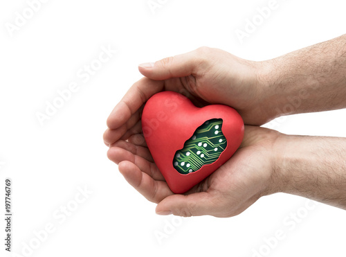 Red computer heart in hands isolated on white with clipping path 