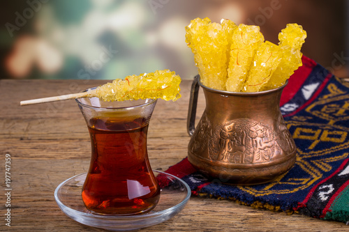 Close Up Of Saffron Rock Candy Sugar Crystal On A Black Tea Cup Is Often Used To Be Dissolved In Tea In Iranian Persian Cuisine