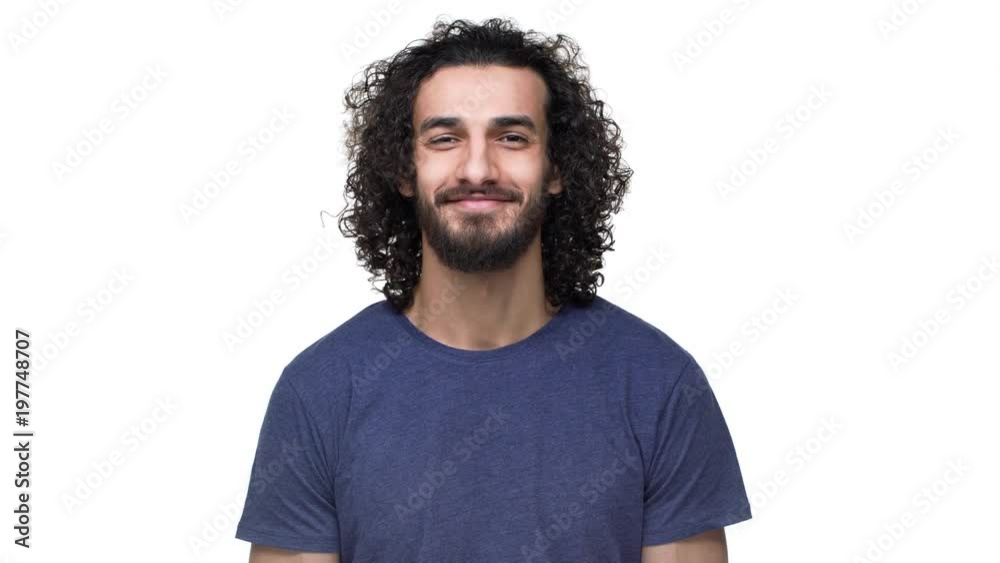 Closeup portrait of brazilian unshaved man in casual dark blue t-shirt expressing acceptance with smile, over white background. Concept of emotions Closeup portrait of brazilian unshaved man in casual dark blue t-shirt expressing acceptance with smile, over white background. Concept of emotions
