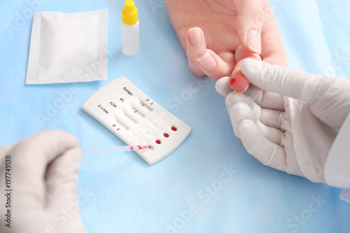 Doctor using test for HIV, Hepatitis B, C and Syphilis, closeup