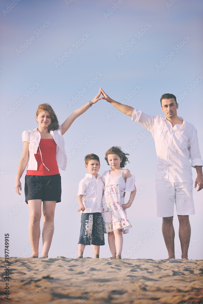 Obraz premium family on beach showing home sign