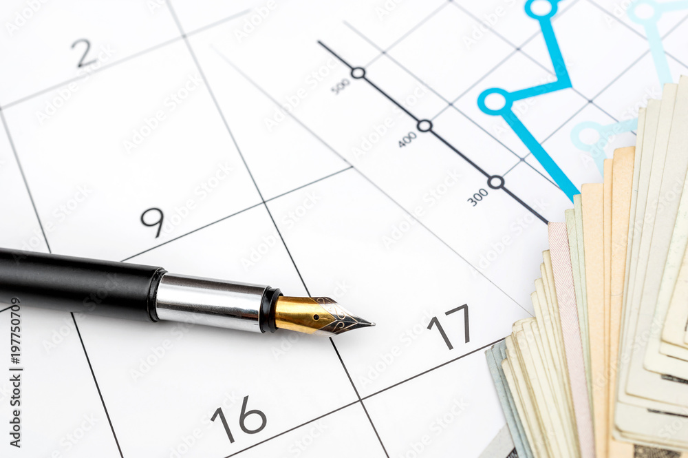 Business concept. Financial graphs with money and pen on calendar. Business concept. Financial graphs with money and pen on calendar.