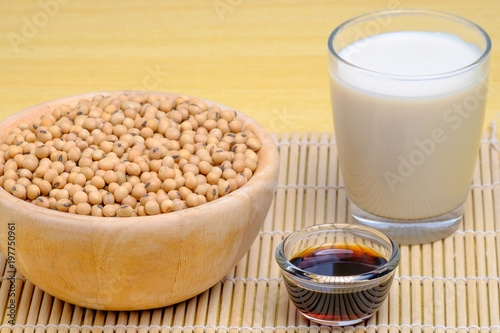 soy milk, soy sauce,soy seeds in wooden and glass dishware