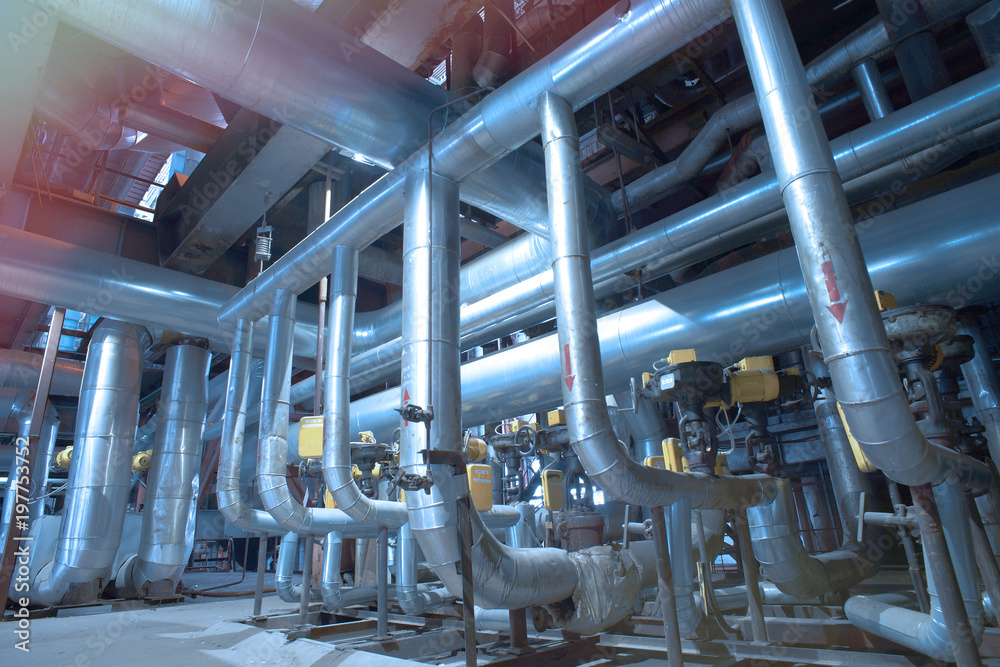 Equipment, cables and piping as found inside of a modern industrial power plant Equipment, cables and piping as found inside of a modern industrial power plant