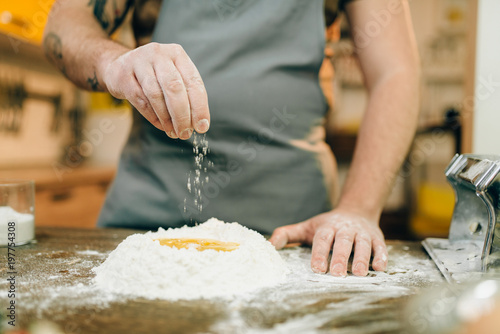 Homemade pasta cooking, man preparing dough