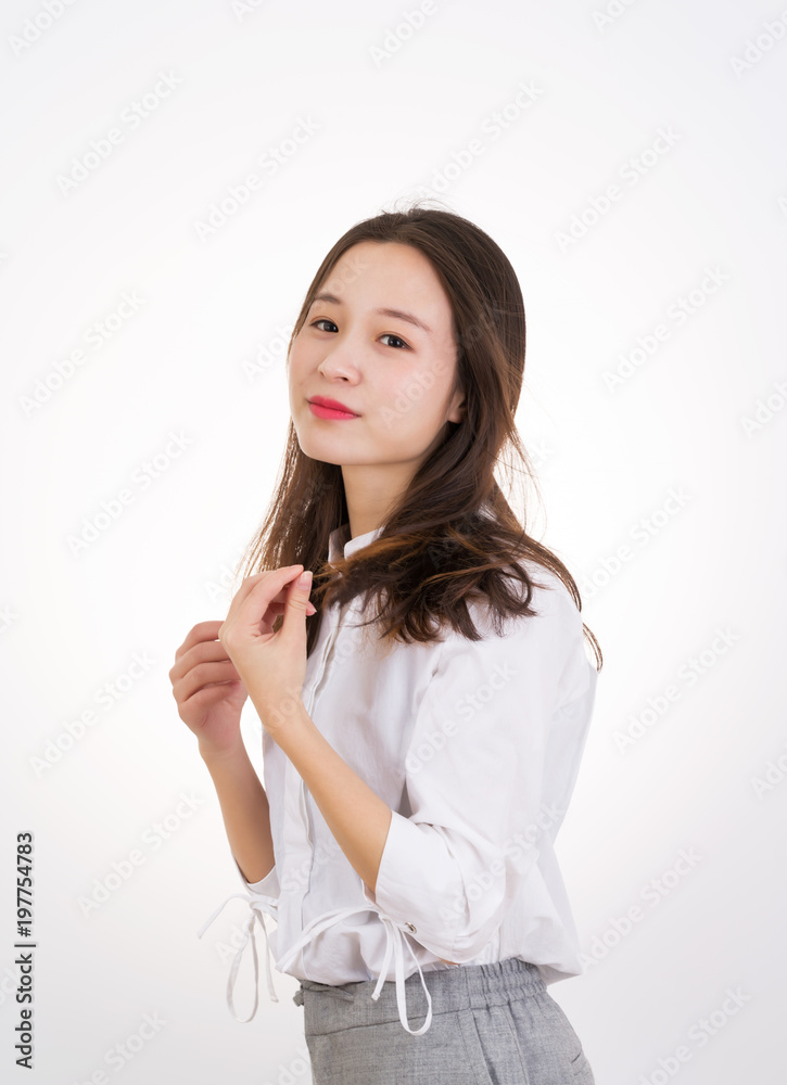 Smiling Young Woman touching her Long and Healthy Hair. Portrait of Young Business Woman.
