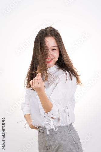 Smiling Young Woman touching her Long and Healthy Hair. Portrait of Young Business Woman. 