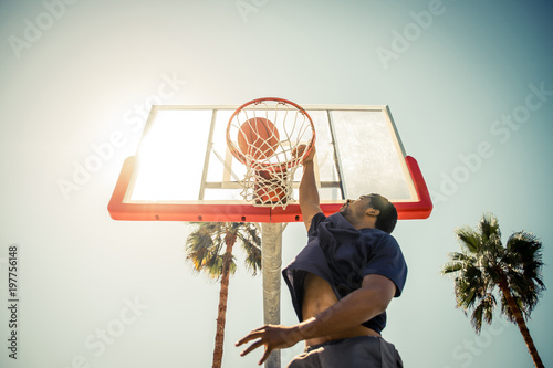 Basketball slam dunk on a californian court