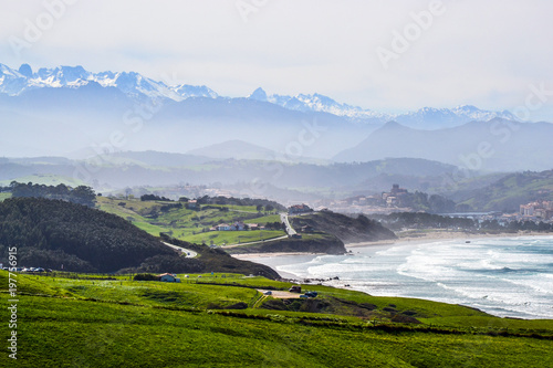 Landscape near Oyambre Beach, in San Vicente de la Barquera, Cantabria, Spain. At the bottom, the Picos de Europa Mountains photo