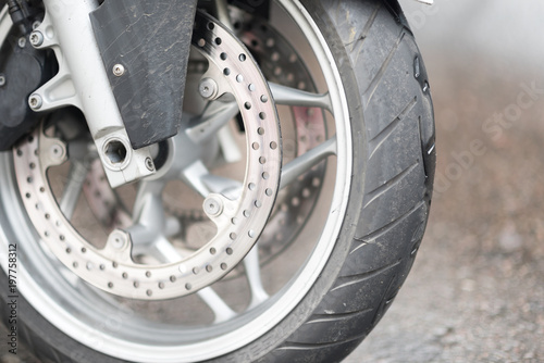 Riders will love. Cropped shot of the wheel of motorbike. Closeup detail of a motorcycle's front wheel and brake disc