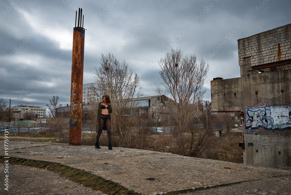 Young slim brunette in lingerie on a ruins of abandoned building Stock  Photo | Adobe Stock