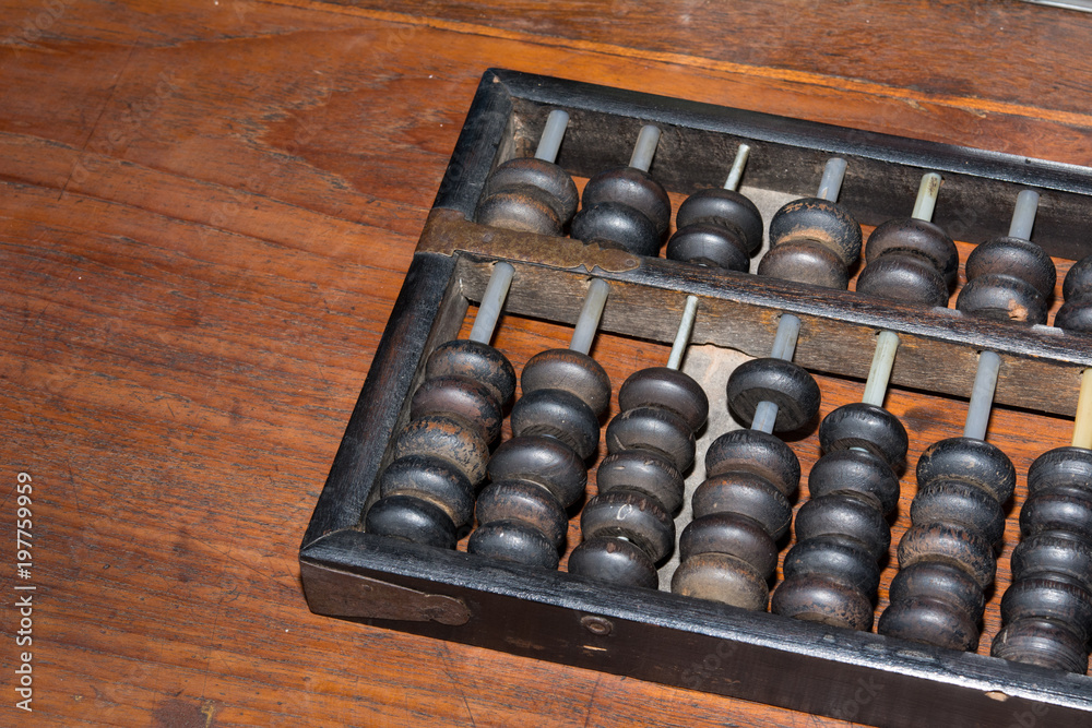 The antique black abacus on wooden table The antique black abacus on wooden table