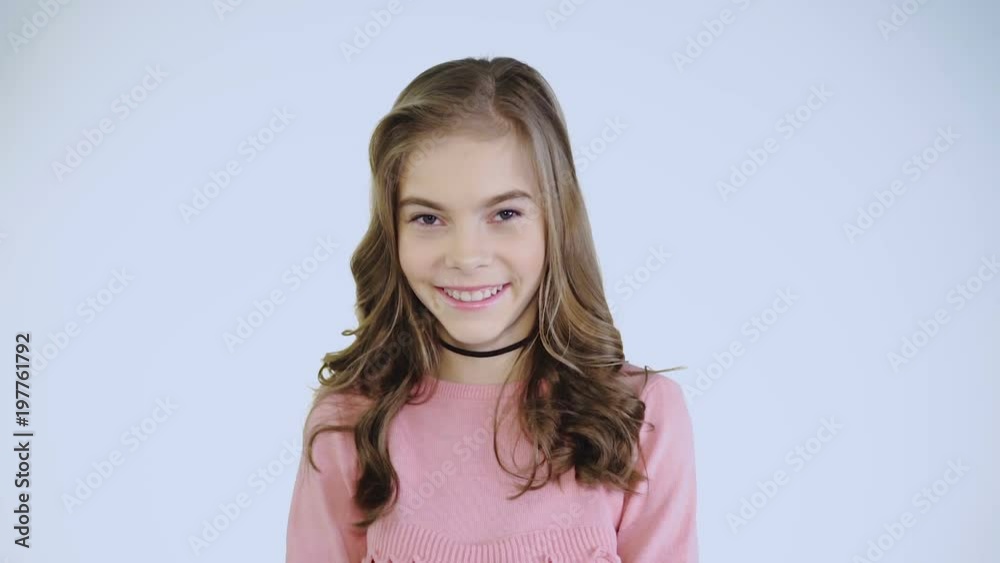 Dissatisfacted girl making face and laughing at camera Dissatisfacted girl making face and laughing at camera