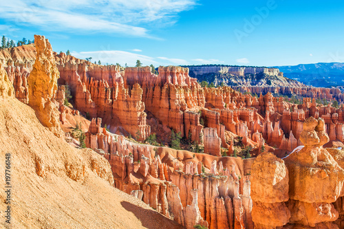 Red-yellow rocks in Bryce Canyon. Panorama of the mountain massif. A tourist place, a stone forest.