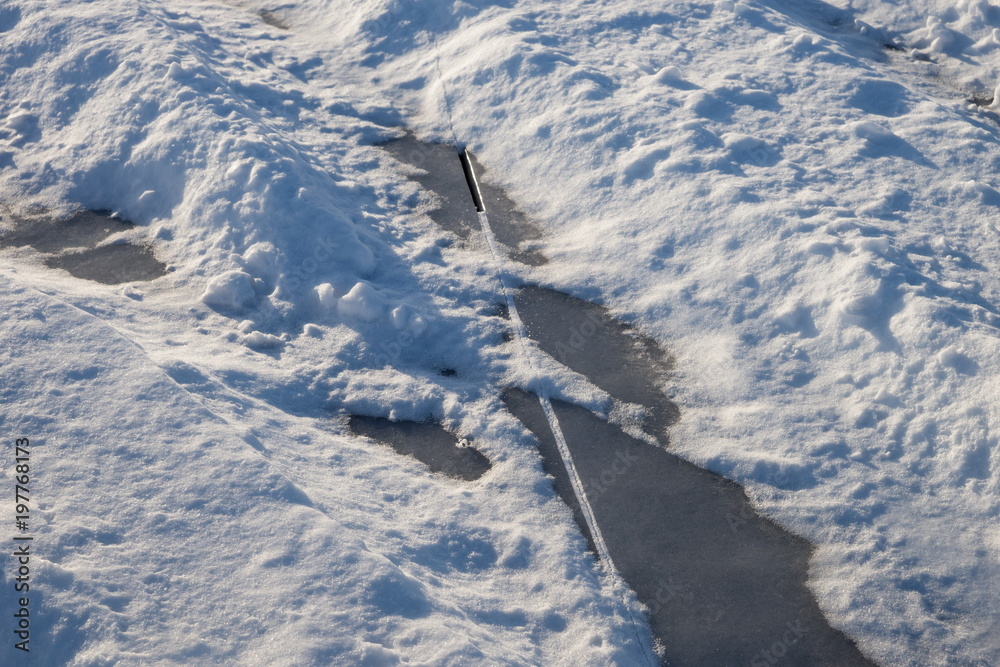 Ice crack on the surface of a snow-covered lake. Ice crack on the surface of a snow-covered lake.