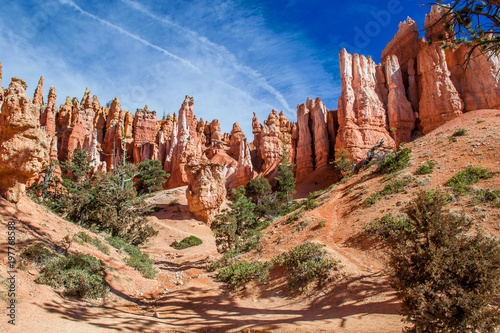 Red-yellow rocks in Bryce Canyon. Panorama of the mountain massif. A tourist place, a stone forest.