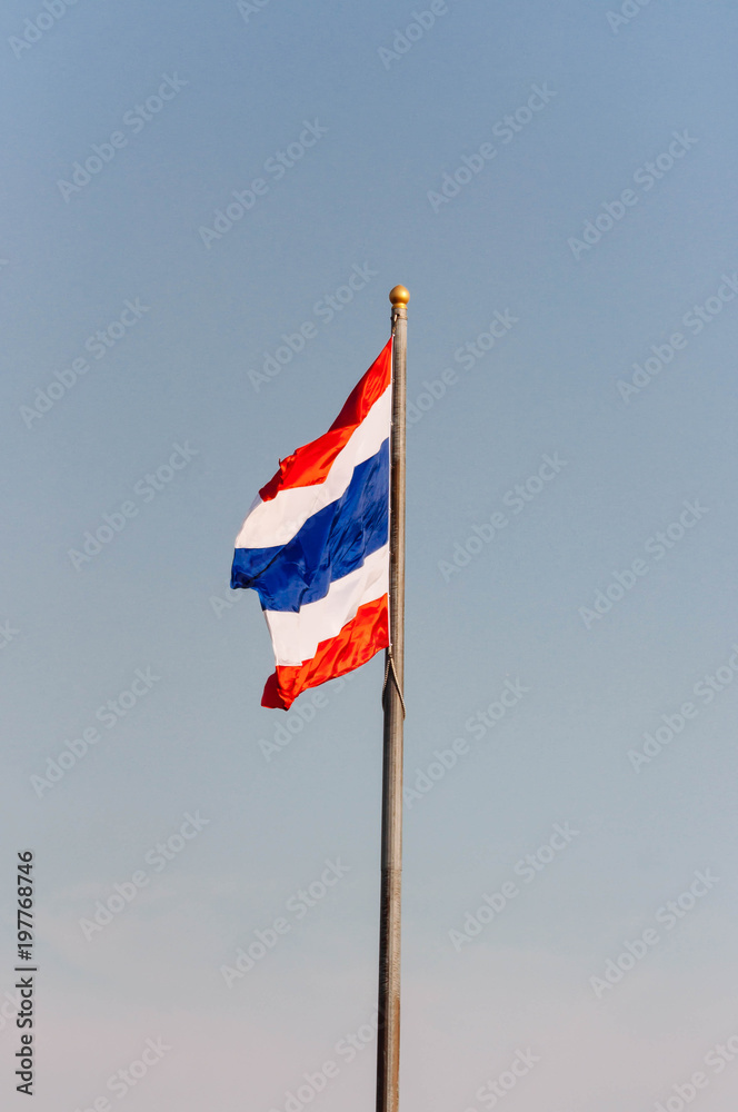 Image of waving Thai Flag of Thailand with blue sky background 