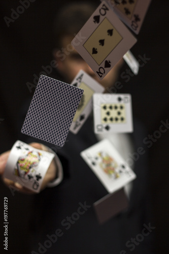 Man with flying playing cards