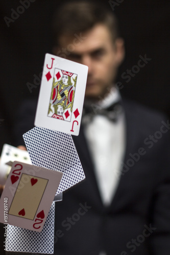 Man with flying playing cards