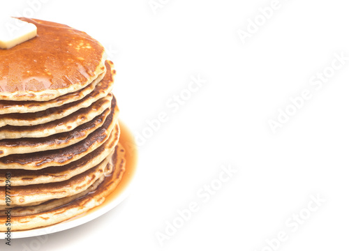 A Stack of Fresh Buttermilk Pancakes with Butter and Syrup on a White Background
