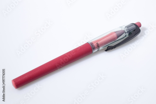 Red pen in a white background composition