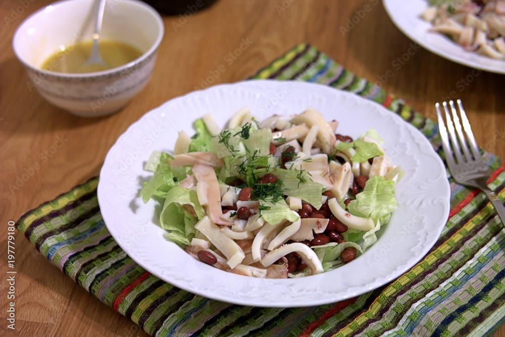 Light salad with squid, beans and lettuce