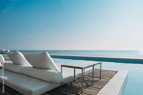 Beautiful luxury swimming pool on sea view and beach chair in hotel resort © arnonphoto