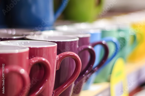 Obraz na plátne set of colorful mug cups on a old wooden table, blurred background